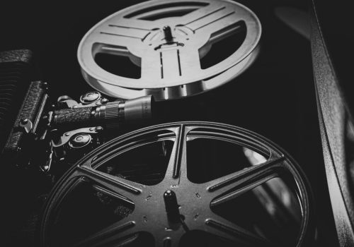 a black and white photo of a movie projector